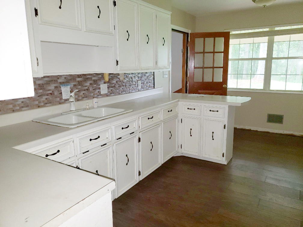 110 Lakeshore Terrace Road Hardy, VA 24101 - Photo 5 of 21 a kitchen with granite countertop white cabinets and sink