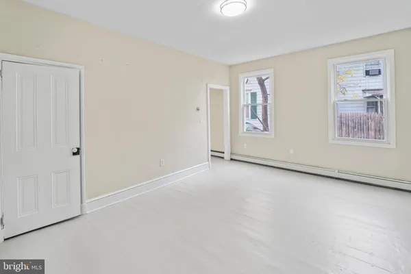 an empty room with windows and closet