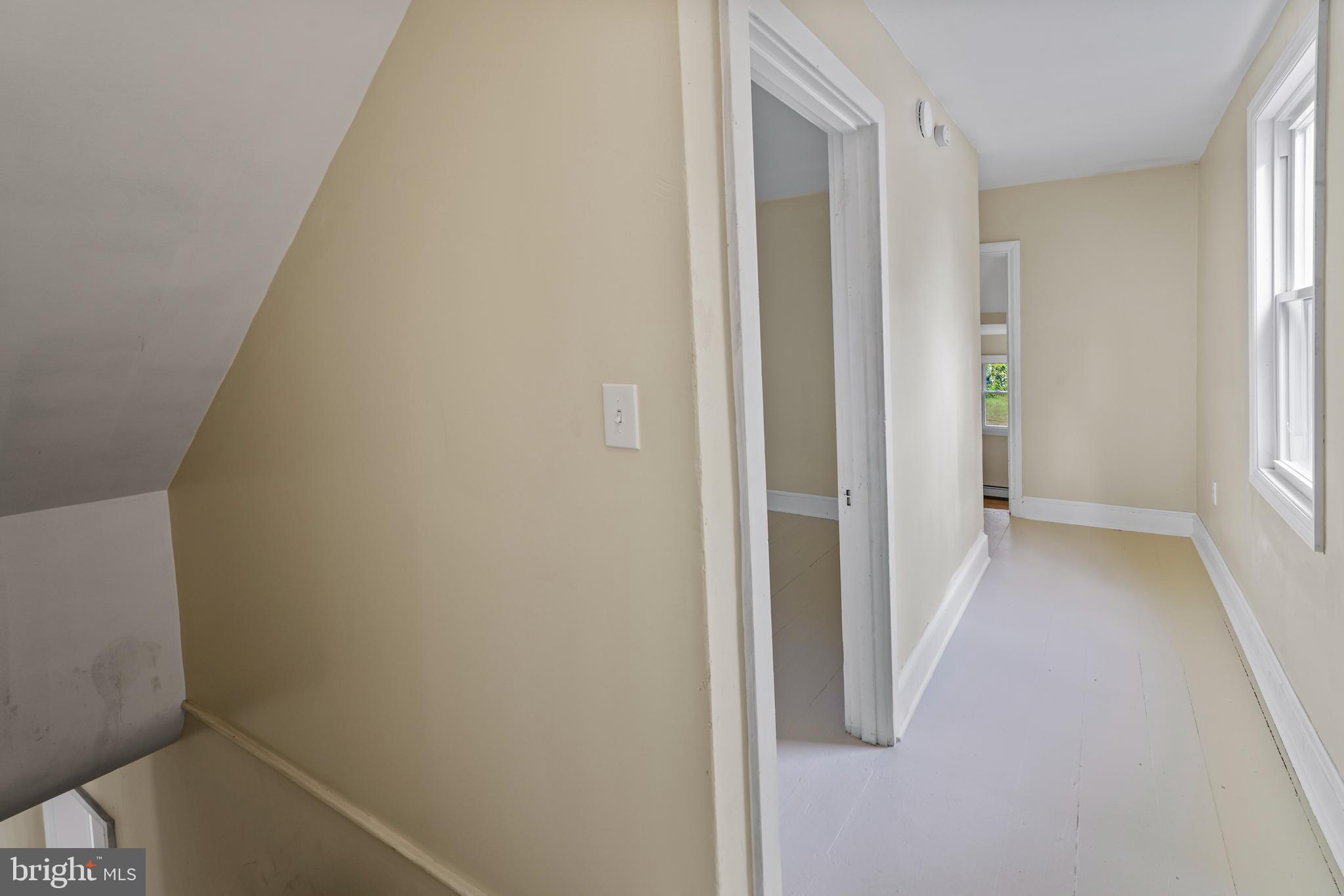 264 East Broadway Salem, NJ 08079 - Photo 27 of 51 a view of a hallway with wooden floor and a bathroom