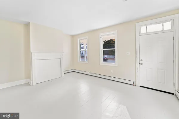 an empty room with windows and closet