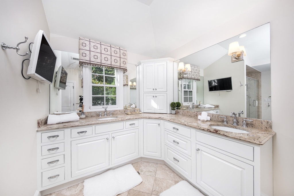 568 Wellesley Street Weston, MA 02493 - Photo 22 of 37 a spacious bathroom with a granite countertop sink and a mirror