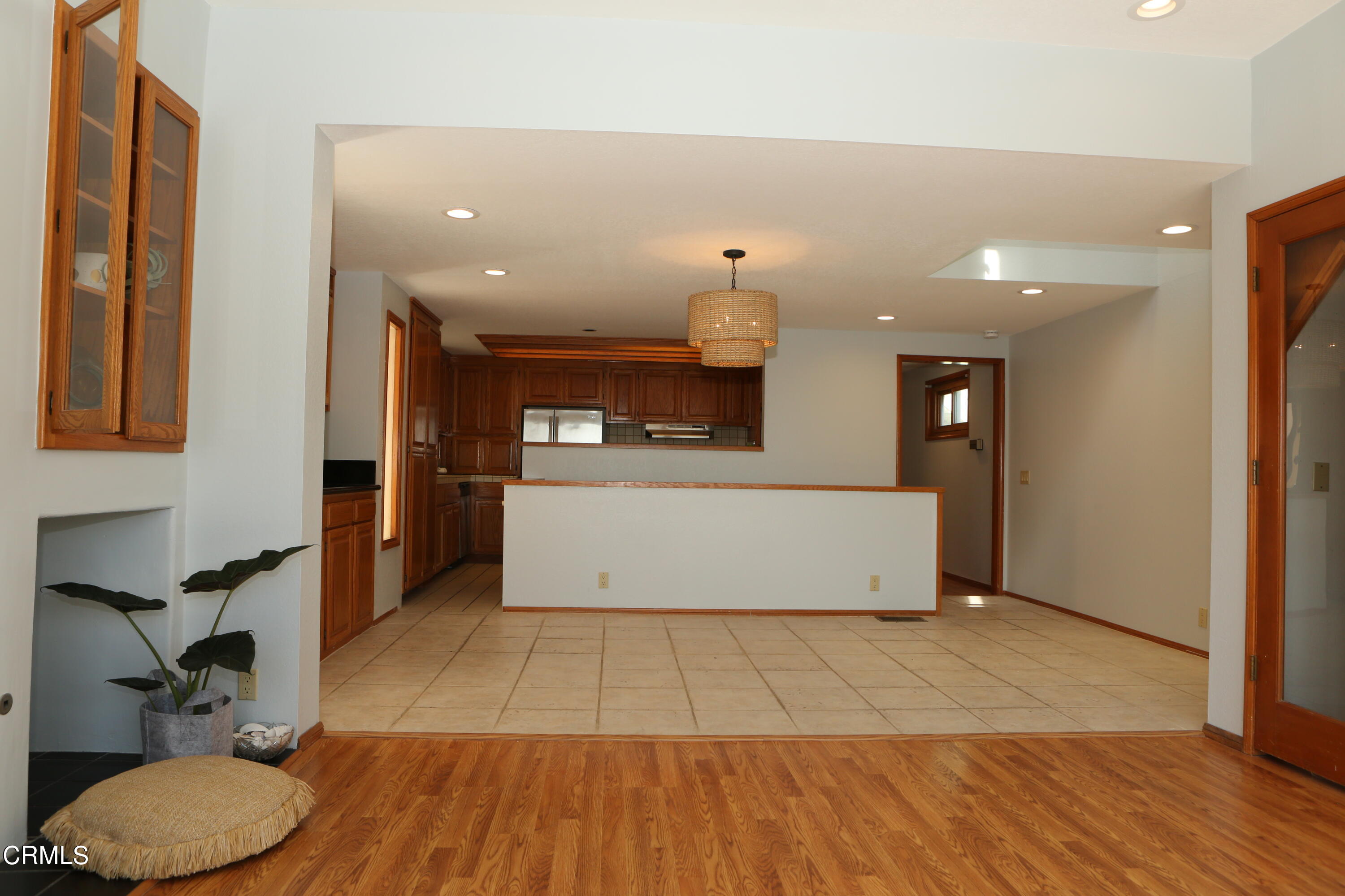 3446 Ocean Drive Oxnard, CA 93035 - Photo 13 of 37 a view of a kitchen with kitchen island a counter top space a sink stainless steel appliances and cabinets