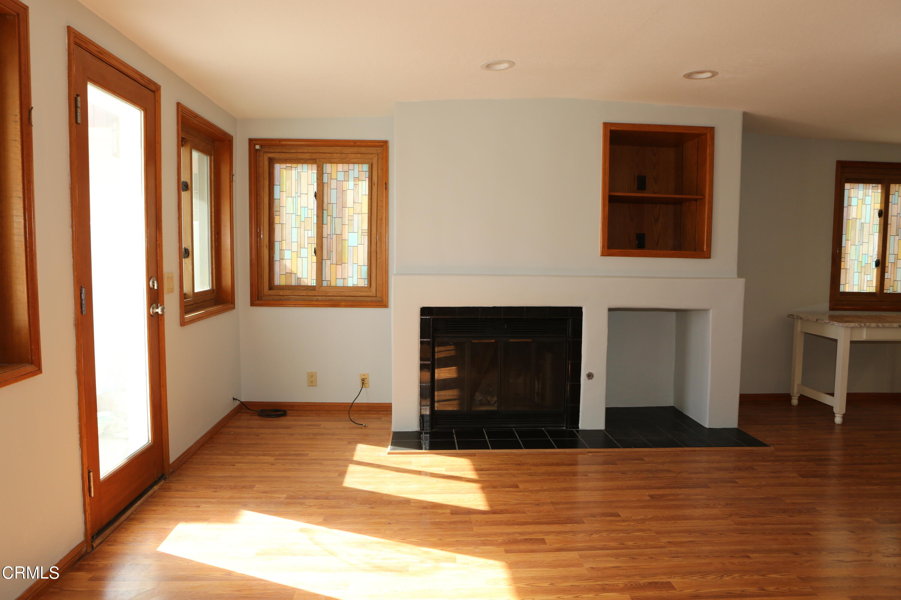 3446 Ocean Drive Oxnard, CA 93035 - Photo 14 of 37 a view of a livingroom with wooden floor and a fireplace
