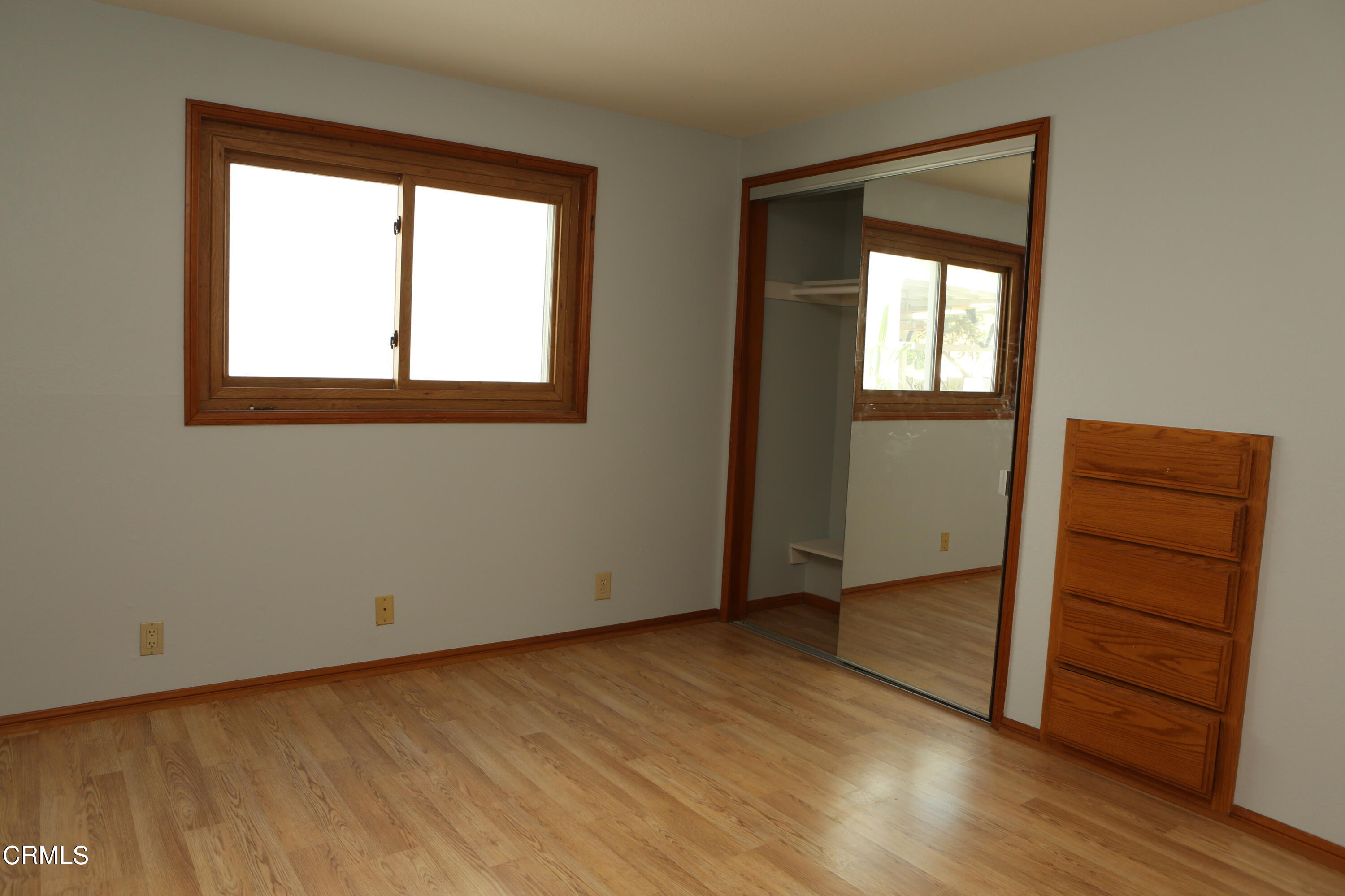 3446 Ocean Drive Oxnard, CA 93035 - Photo 22 of 37 an empty room with wooden floor closet and windows