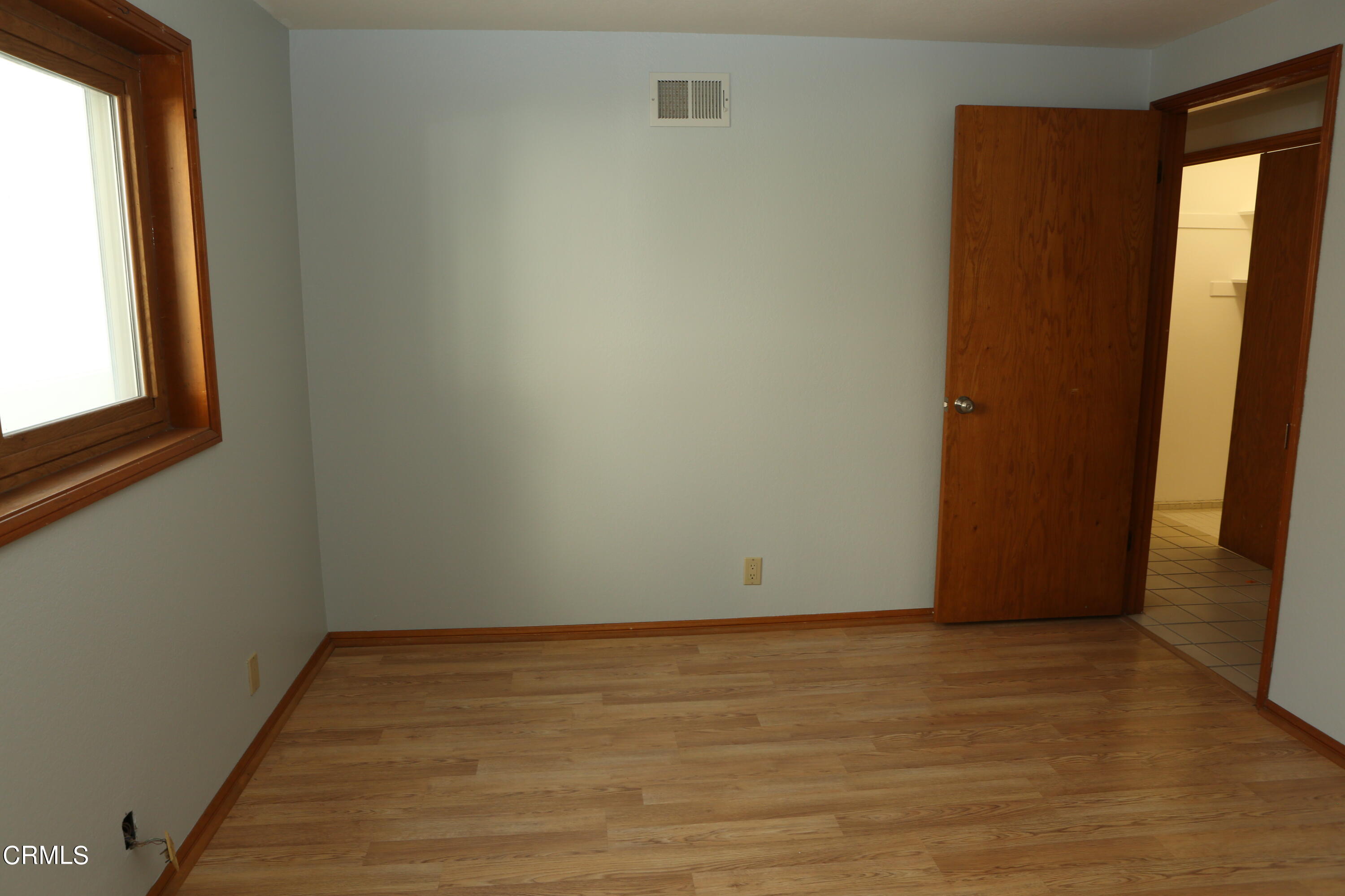 3446 Ocean Drive Oxnard, CA 93035 - Photo 25 of 37 a view of an empty room with wooden floor and a window