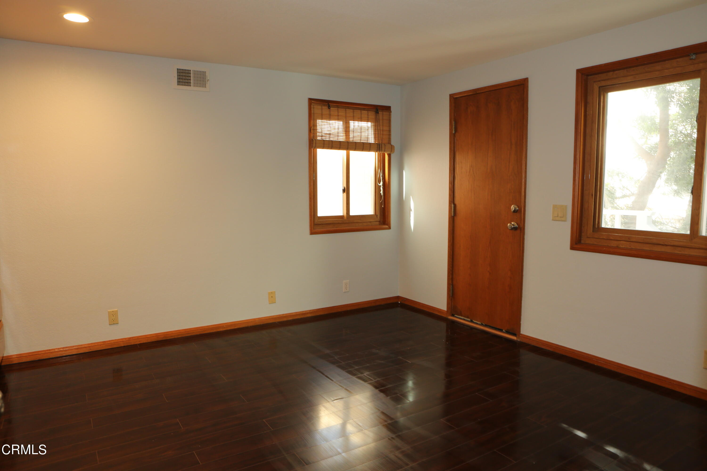 3446 Ocean Drive Oxnard, CA 93035 - Photo 27 of 37 an empty room with wooden floor and windows