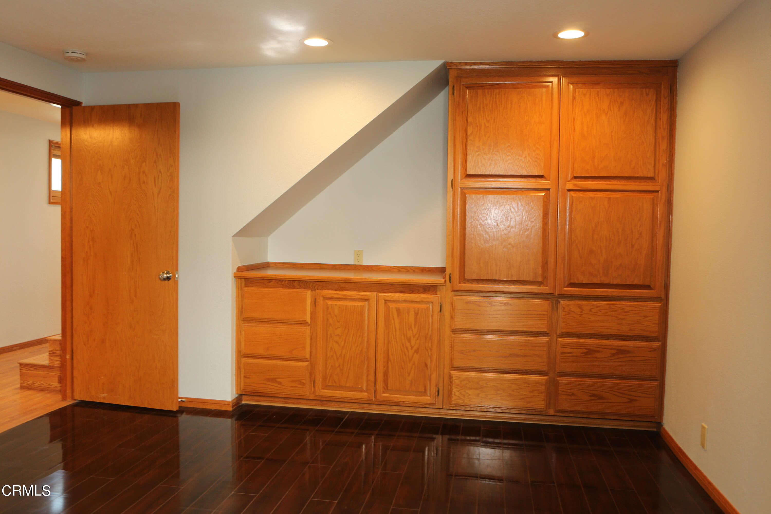 3446 Ocean Drive Oxnard, CA 93035 - Photo 29 of 37 an empty room with wooden floor and cabinet