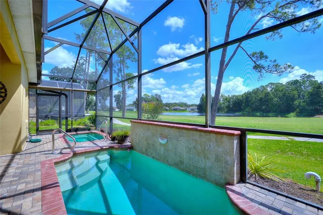 an aerial view of a house with a garden and lake view