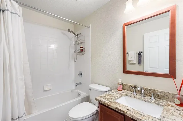 a living room with lots of furniture and a table