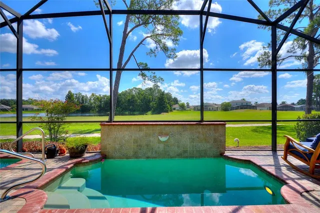 a front view of a house with a yard and potted plants