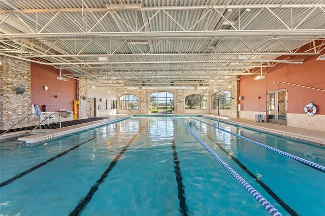 a view of a swimming pool with a table and chairs