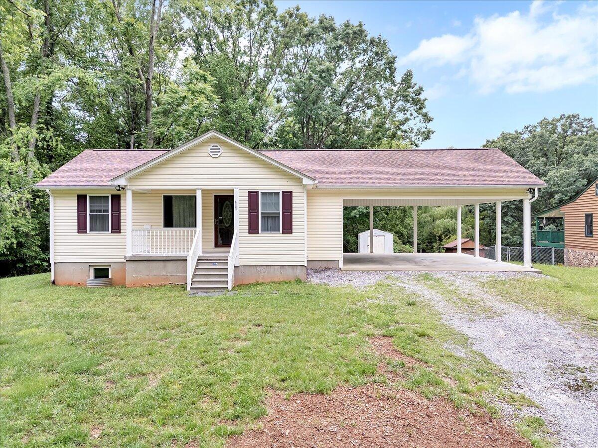 4131 Rutrough Road Southeast Roanoke, VA 24014 - Photo 1 of 42 a front view of a house with a yard table and chairs