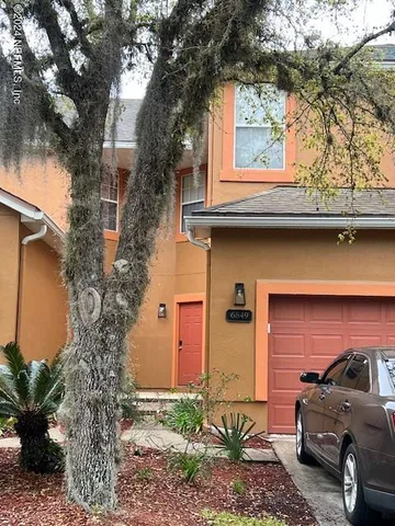 a view of a car parked in front of a house