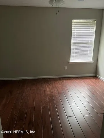 a view of a room with wooden floor and windows
