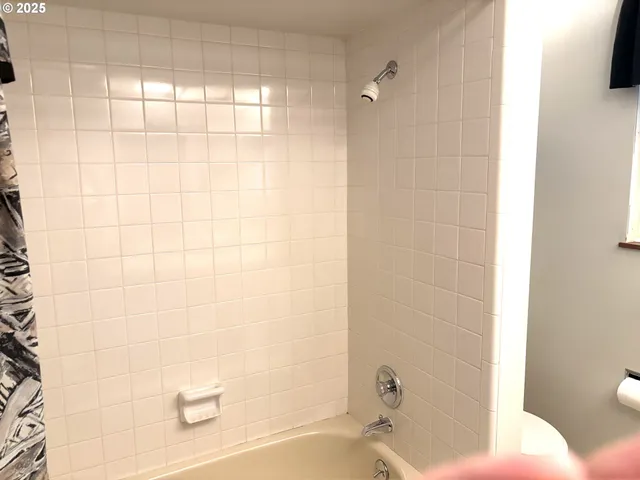 a view of a room with wooden floor and a window