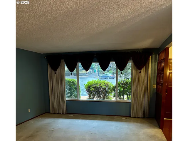 a room with a large window and front door