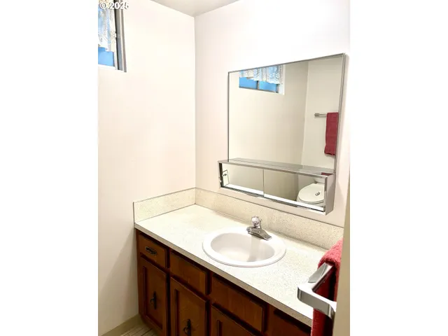 a bathroom with a toilet a sink and shower