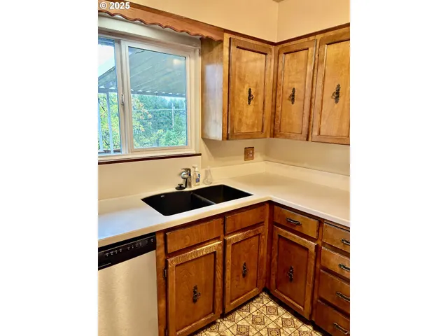 a kitchen with stainless steel appliances a refrigerator and cabinets