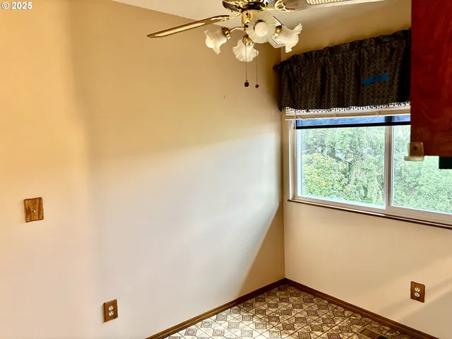 a view of a livingroom with a fireplace and window