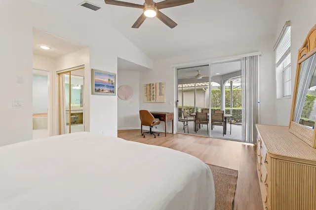 a bedroom with a bed and large windows