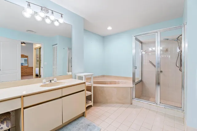a bathroom with a tub a sink and mirror