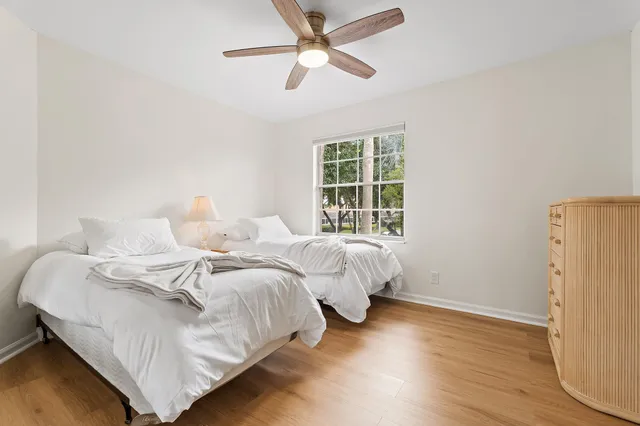 a bed room with two beds and a window