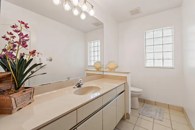 a bathroom with a sink a vanity and a mirror
