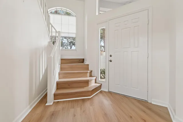 a view of entryway and hall with wooden floor