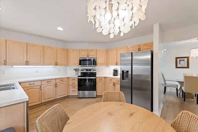 a kitchen with stainless steel appliances a refrigerator sink and stove