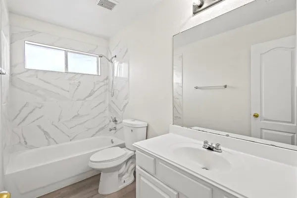 a bathroom with a sink toilet and shower