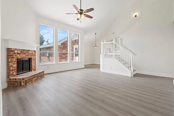 wooden floor in an empty room with a fireplace