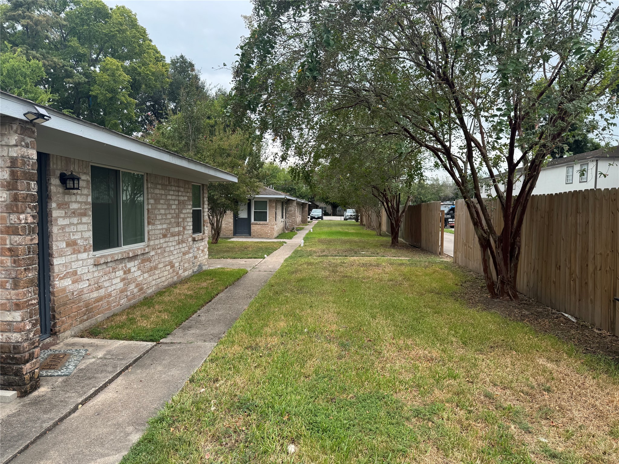 604 Wilson Road, Unit 8 Humble, TX 77338 - Photo 18 of 25 Sidewalk to Parking Area
