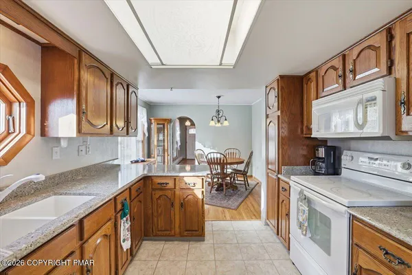 a kitchen with stainless steel appliances granite countertop a sink and cabinets
