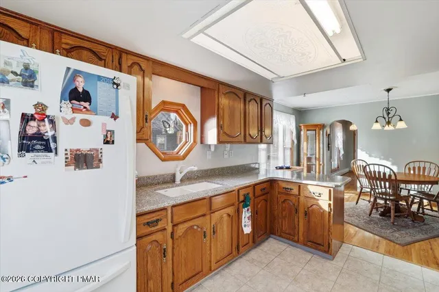 a kitchen with stainless steel appliances granite countertop a refrigerator and a stove