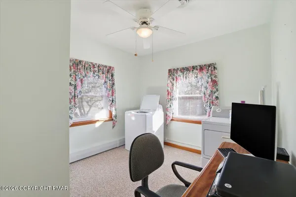 a view of a workspace with furniture and entryway