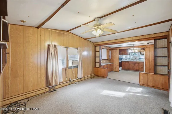 a large kitchen with a large window and stainless steel appliances