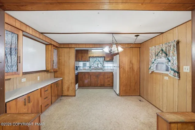a view of a hallway with wooden floor and front door