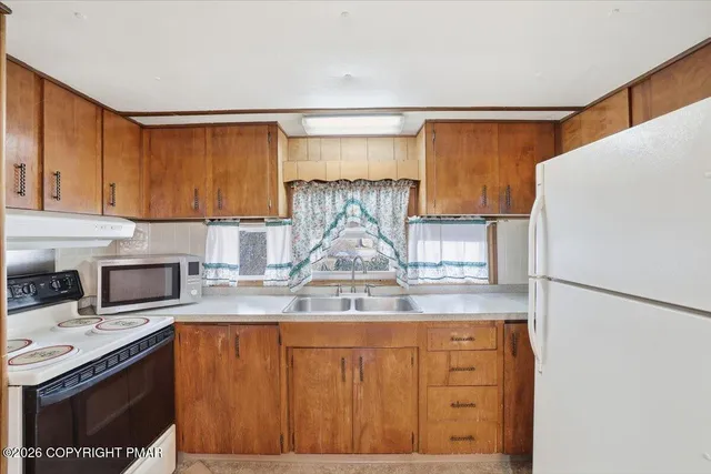 a kitchen with a sink cabinets and window