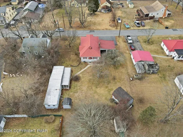an aerial view of residential houses with outdoor space