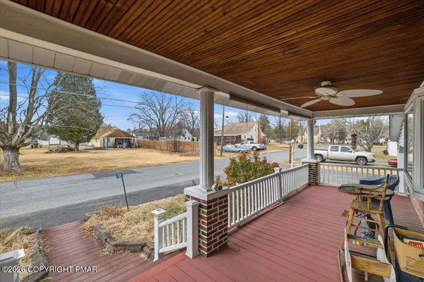 a view of a porch and wooden floor