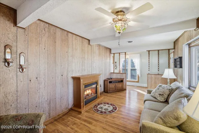 a living room with furniture a fireplace and a chandelier