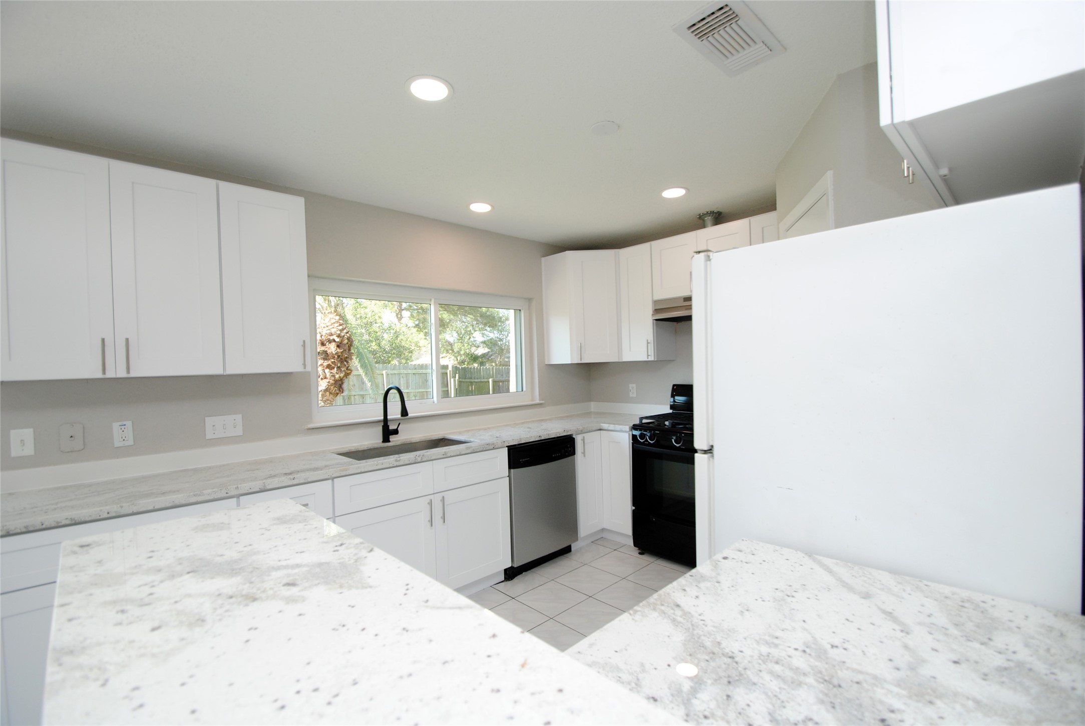 22831 John Rolfe Lane Katy, TX 77449 - Photo 14 of 34 a kitchen with stainless steel appliances granite countertop a sink and a stove