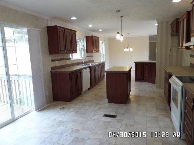 1552 Union School Road Southwest Floyd, VA 24091 - Photo 14 of 40 a kitchen with kitchen island granite countertop a refrigerator and a stove top oven