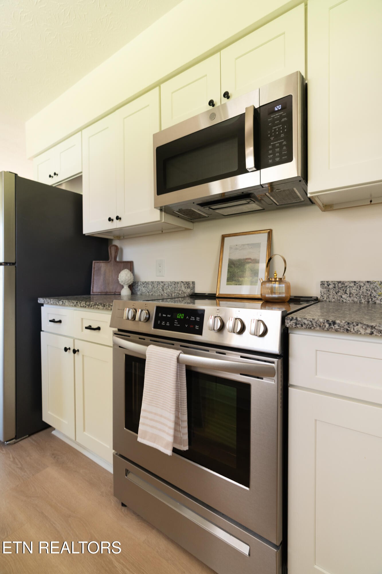 520 Harrow Road Knoxville, TN 37934 - Photo 26 of 42 a kitchen with stainless steel appliances a stove microwave and white cabinets