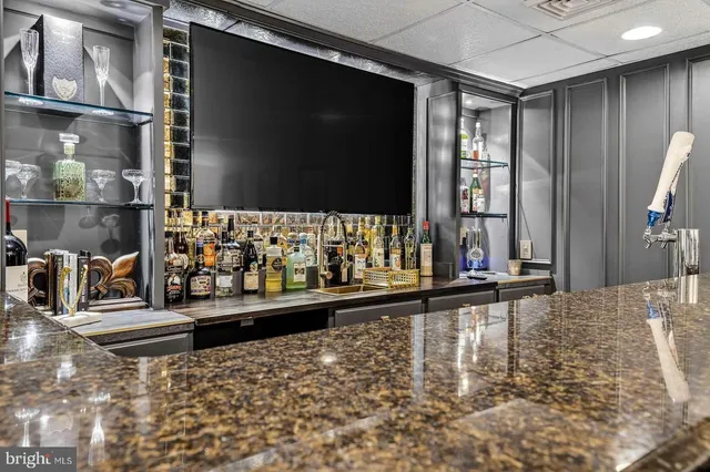 a kitchen with stainless steel appliances granite countertop a sink and a refrigerator