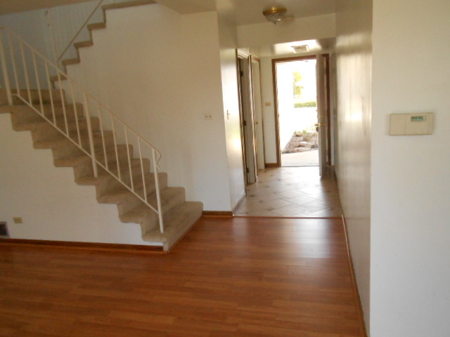 2023 Raleigh Place Hoffman Estates, IL 60169 - Photo 4 of 10 a view of a hallway with wooden floor and staircase