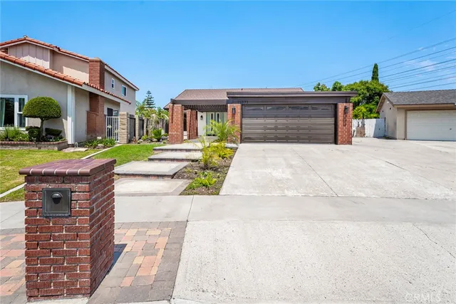 a front view of a house with a yard and a garage