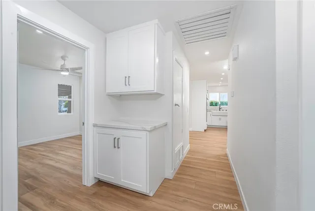 an empty room with a ceiling fan and wooden floor
