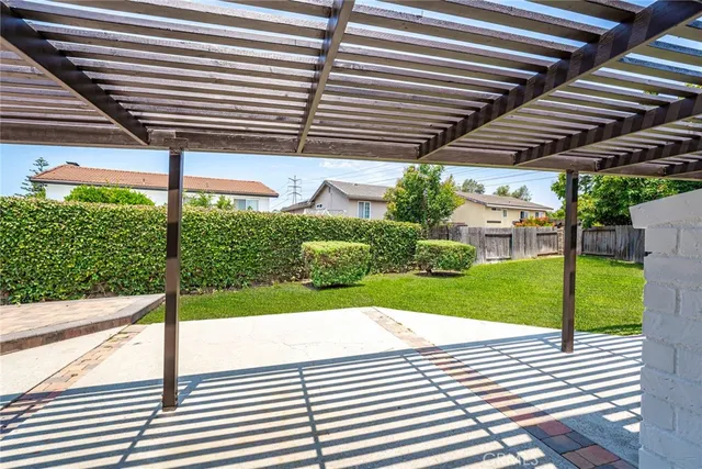 a front view of a house with yard and deck