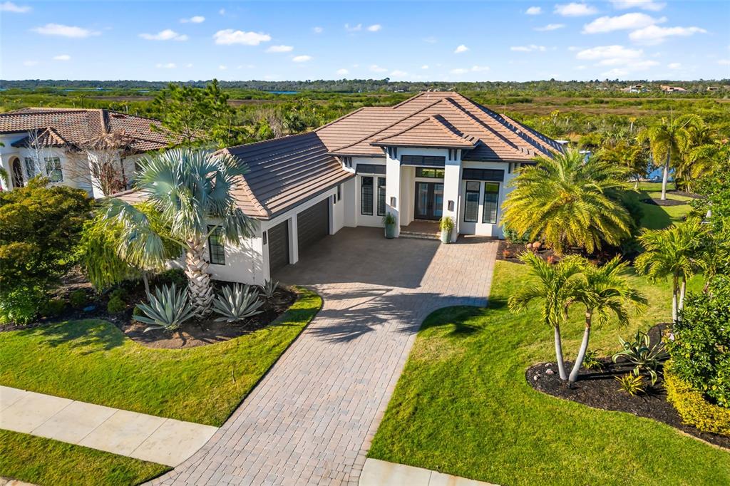 a front view of house with a garden and swimming pool